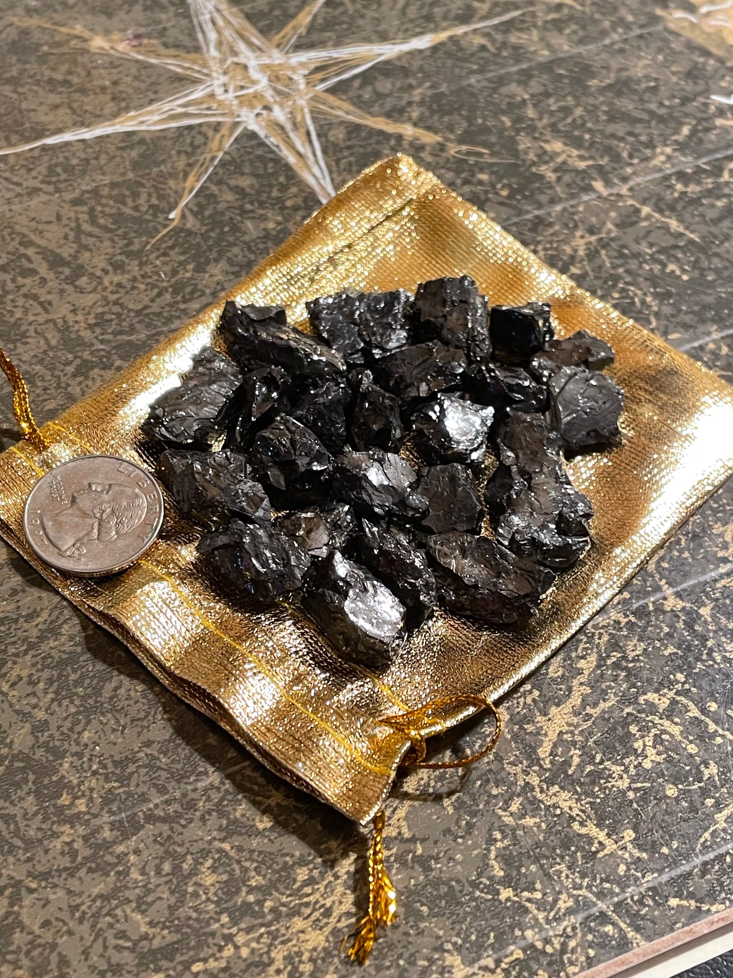Elite Shungite pieces in gold pouch.